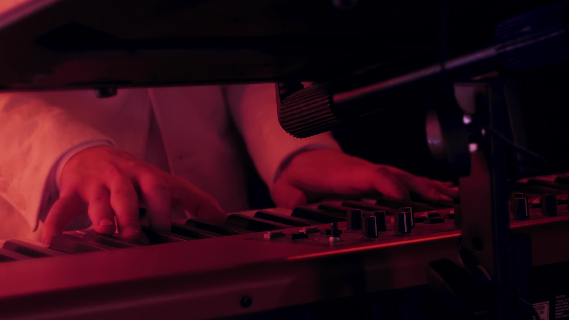 Close-up of the hands of a pianist playing a song on a keyboard